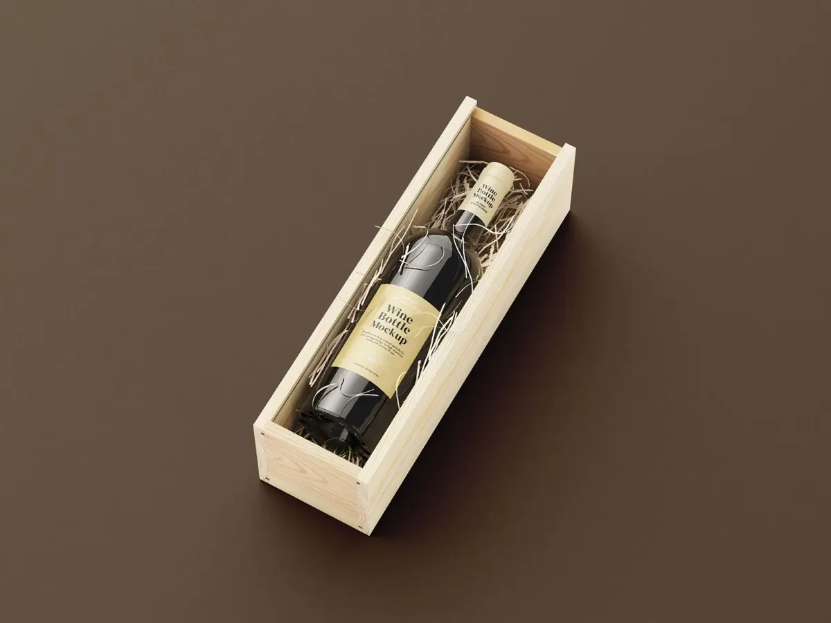 Wine bottle in an open wooden gift box lined with packing straw, on a plain dark brown background.