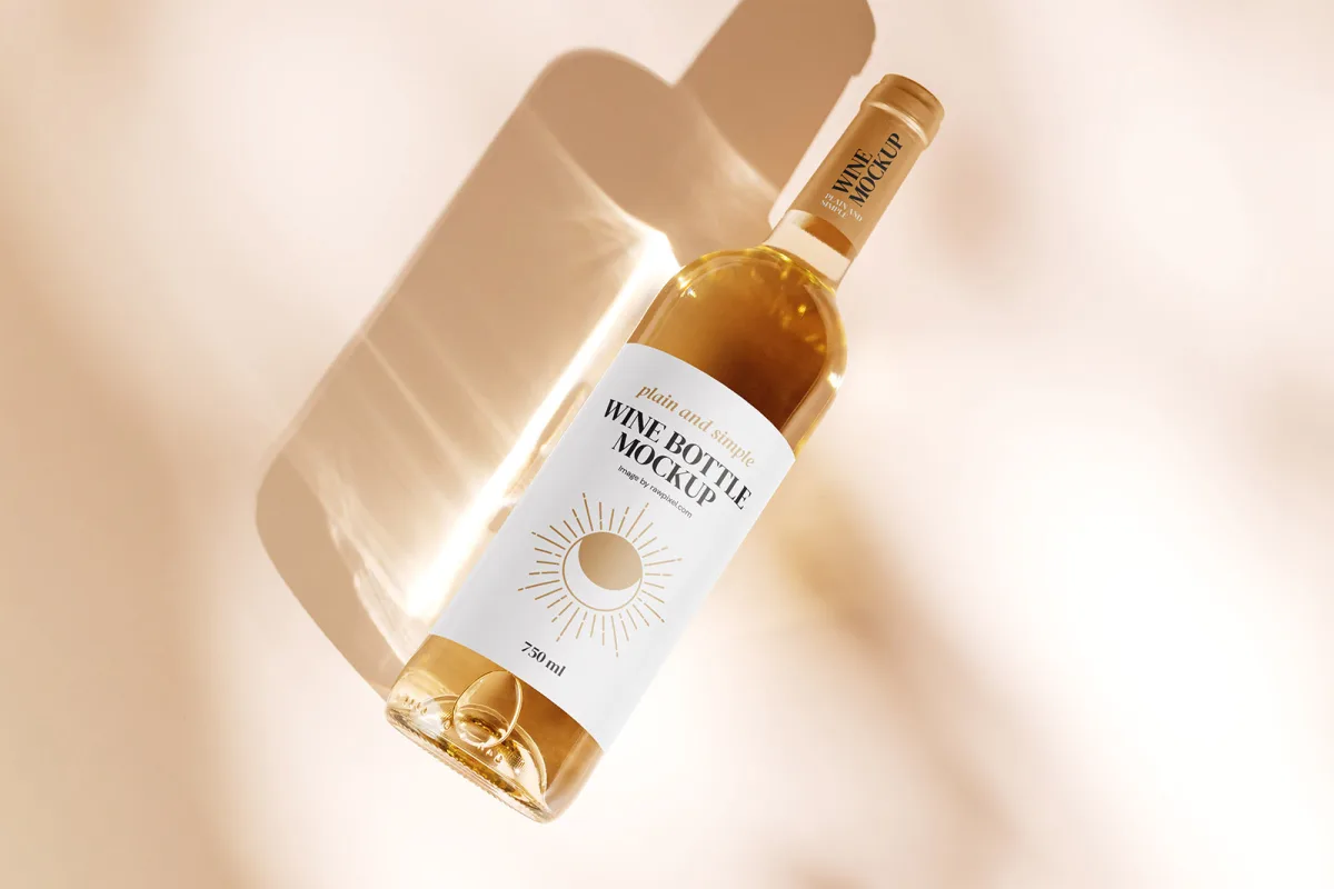 Golden white wine bottle mockup with plain and simple Wine Bottle Mockup label, dramatic warm lighting and hard shadow across a beige background.