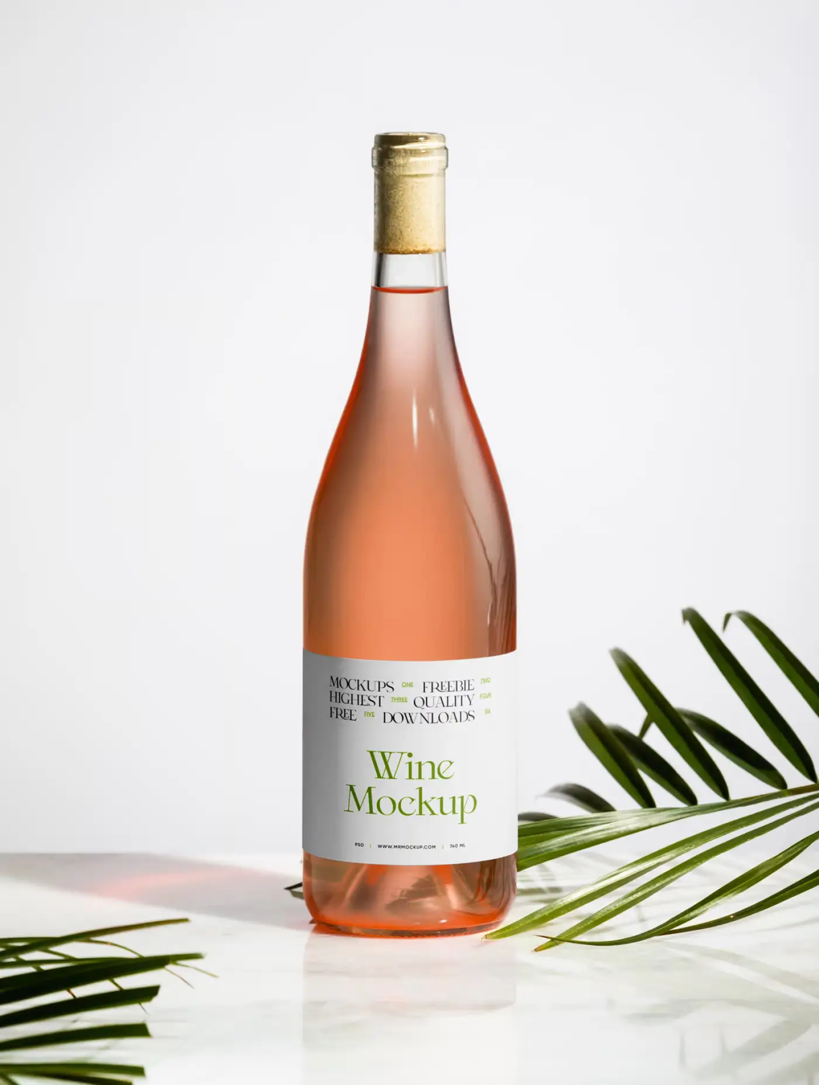 Rosé wine bottle with white Wine Mockup label, standing on a marble surface with palm leaves and warm light flare, plain background.